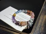 Close-up of the bracelet's core crystals, featuring Gold Rutilated Quartz, Green Phantom Quartz, Amethyst, and others.