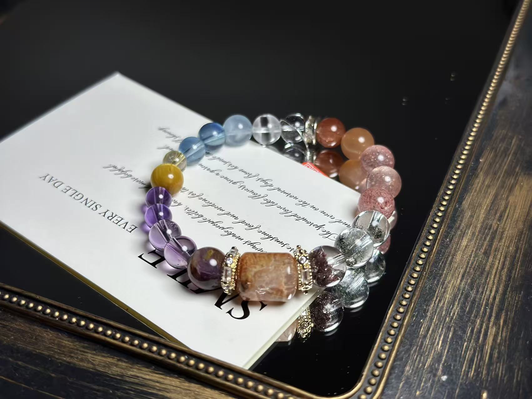 Close-up of the bracelet's core crystals, featuring Gold Rutilated Quartz, Green Phantom Quartz, Amethyst, and others.