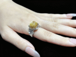 Model wearing the Gold Rutilated Quartz ring on finger, showcasing a powerful aura and exceptional confidence.