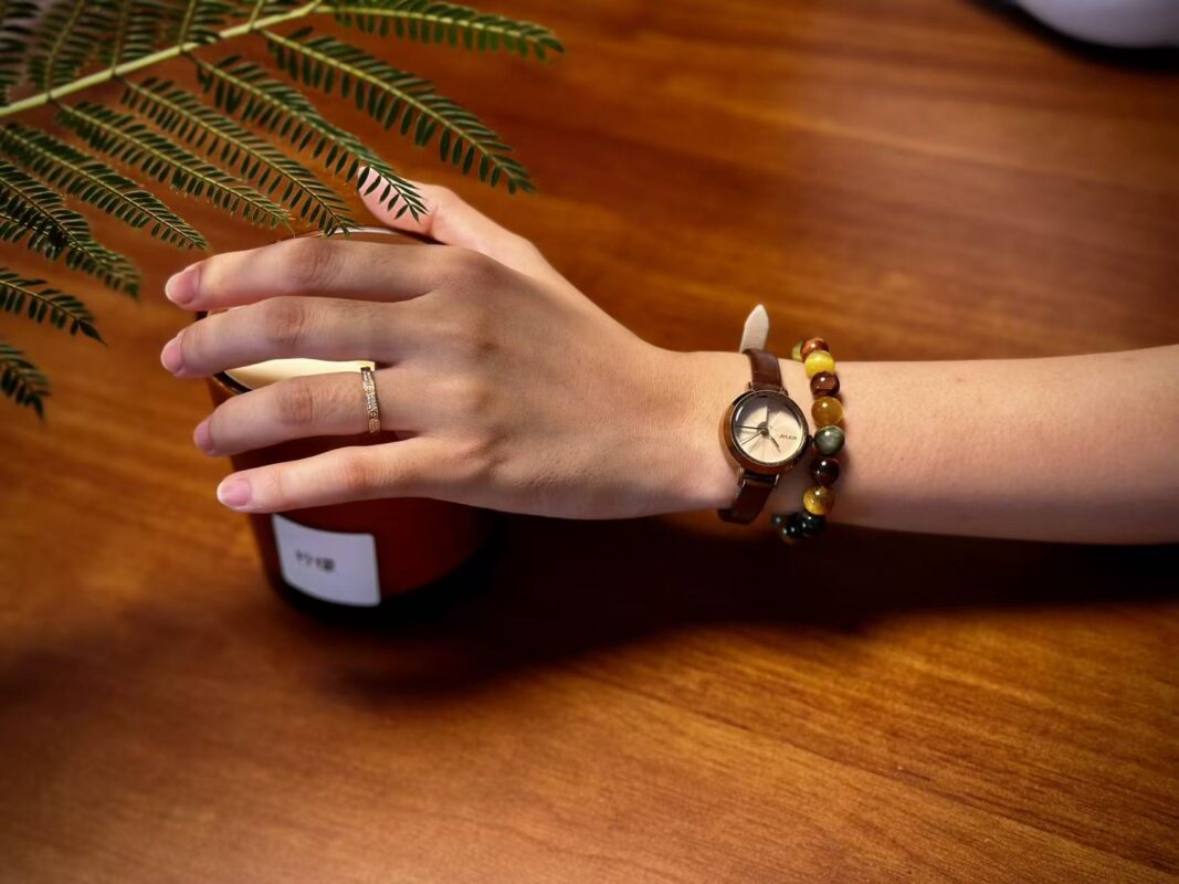 Model wearing the Multi-color Tiger's Eye bracelet on wrist, showcasing confident strength and unique style.
